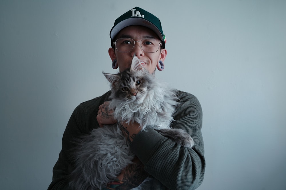 a man holding a cat in his arms