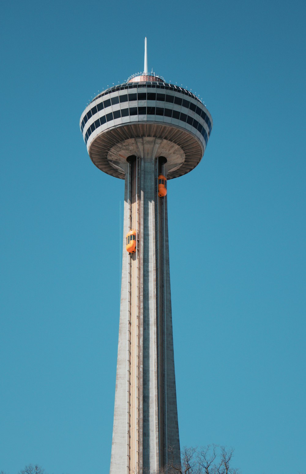 a very tall tower with a clock on it's side