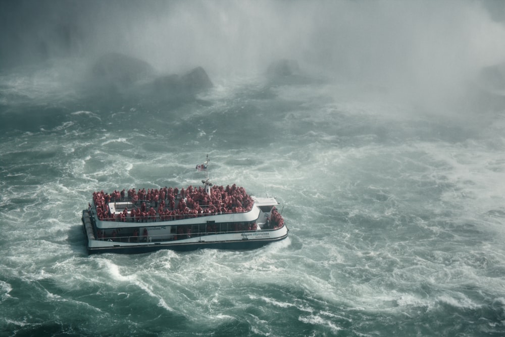 a boat full of people in the middle of a large body of water