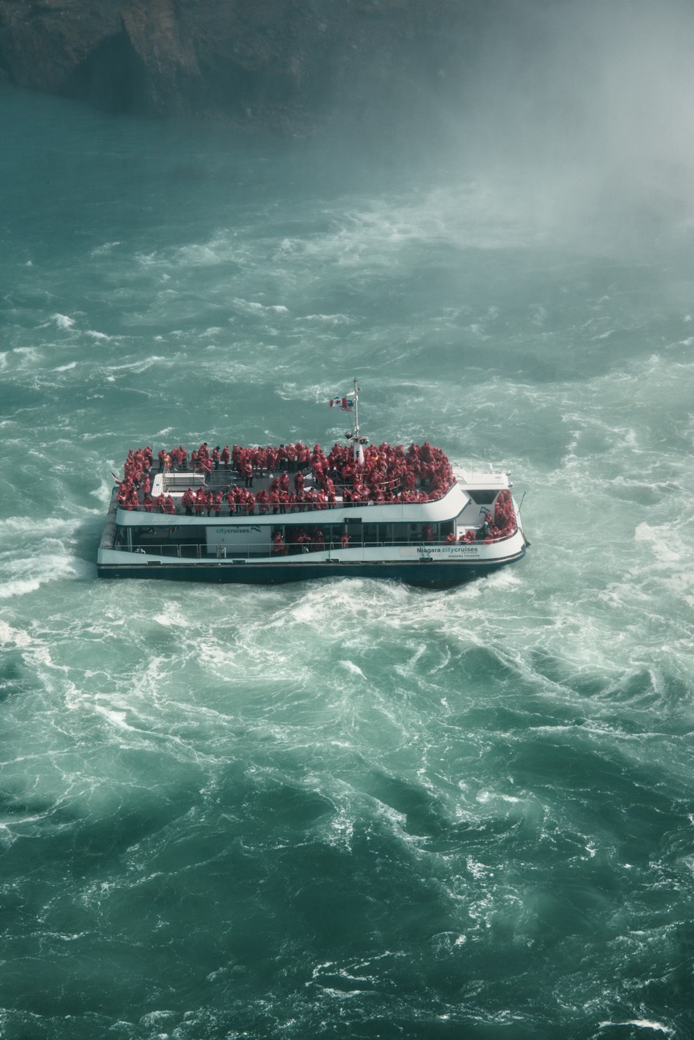 a large boat full of people in the water
