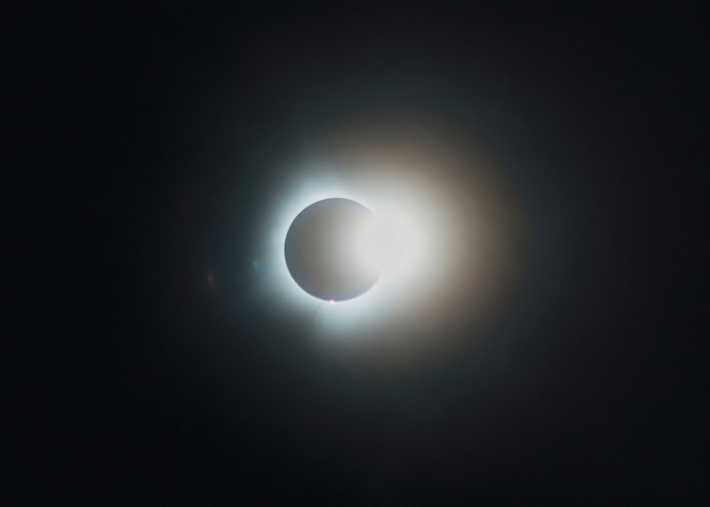 a solar eclipse seen through the dark sky