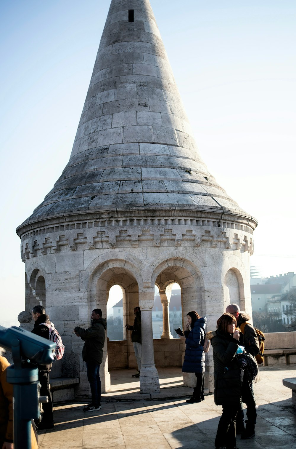 a group of people standing around a stone structure