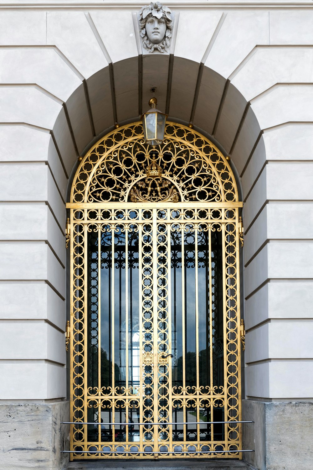 a gold gate with a clock on top of it