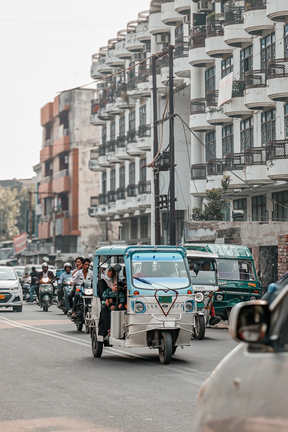 a group of people riding motorcycles down a street