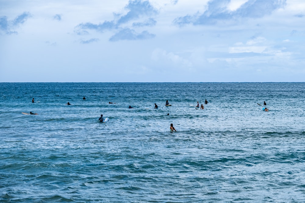 a group of people swimming in the ocean