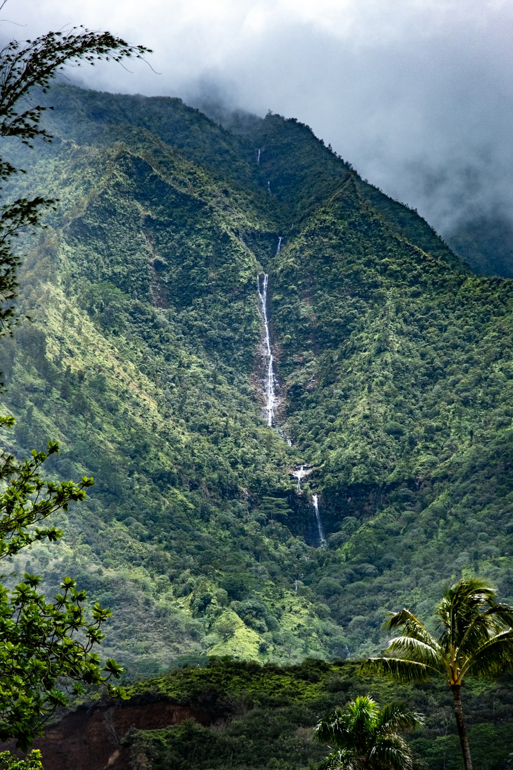 a mountain with a waterfall in the middle of it