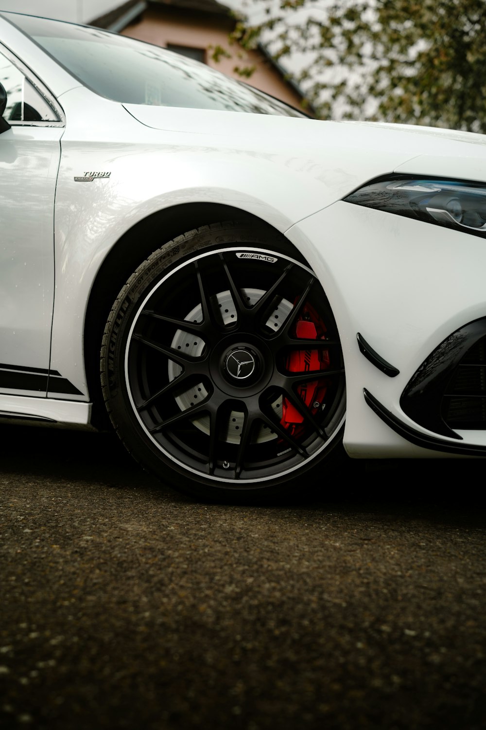 a white sports car parked on the side of the road