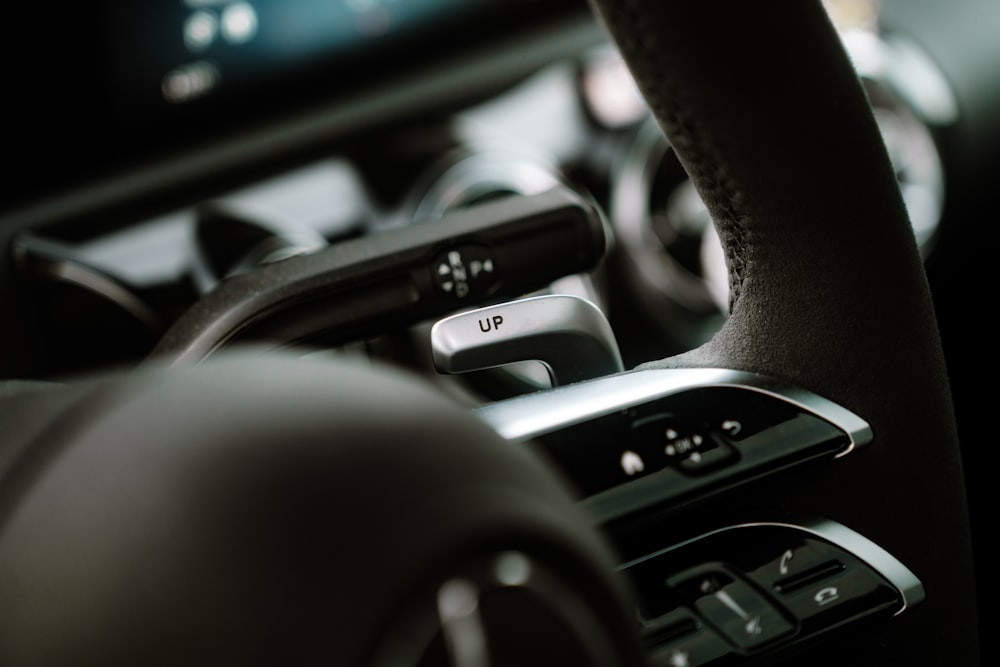 a close up of a car's steering wheel and dashboard