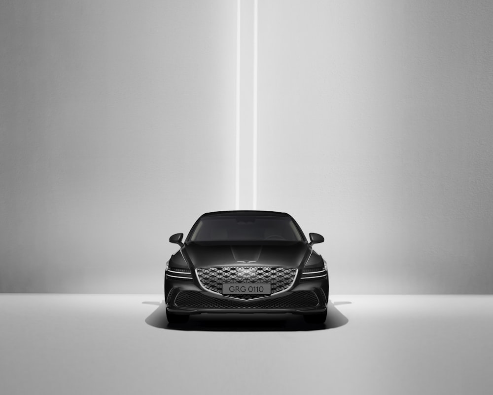 a black car is shown in the middle of a room