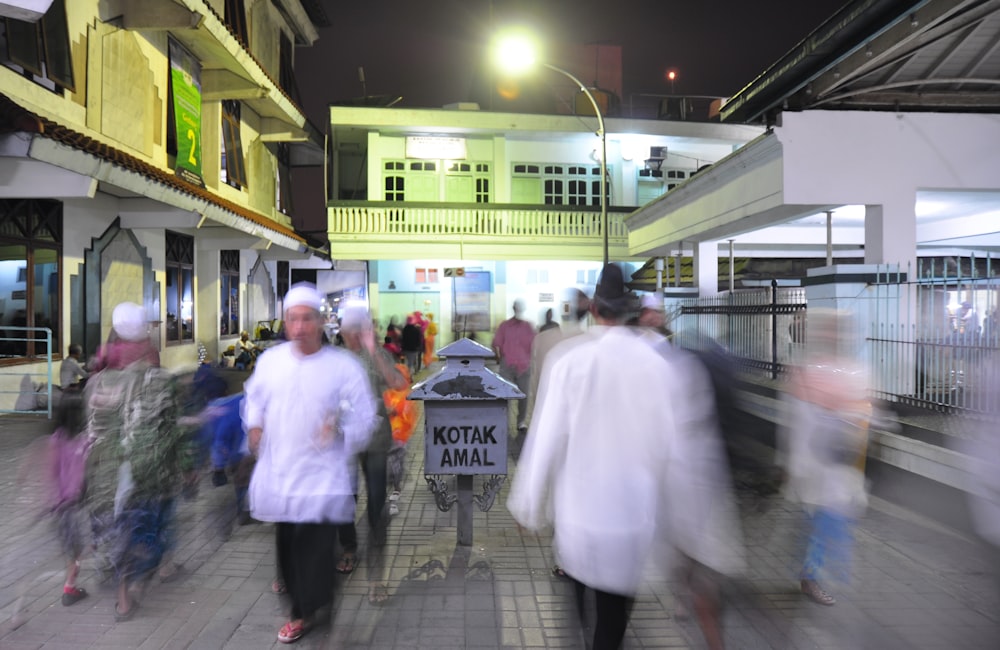 a blurry photo of people walking down a sidewalk