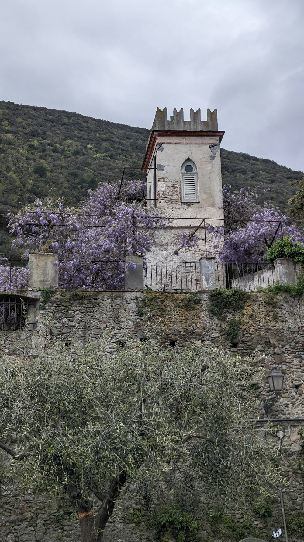 a tower with a clock on top of a hill