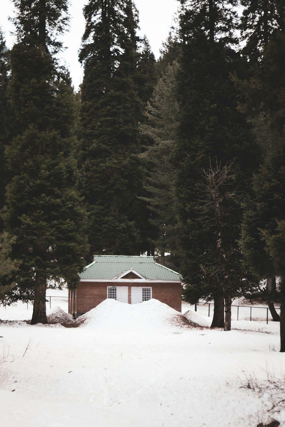 a house in the middle of a snow covered field