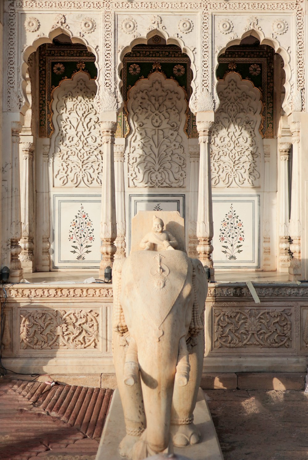 a statue of an elephant in front of a building