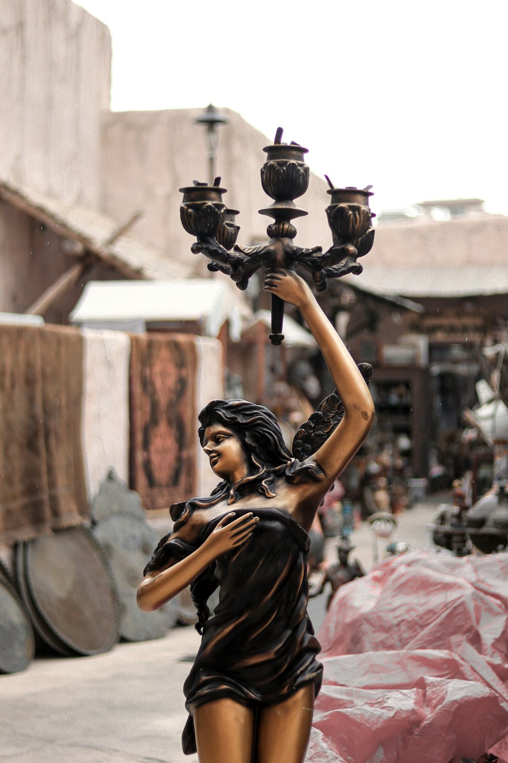 a statue of a woman holding a candelabra