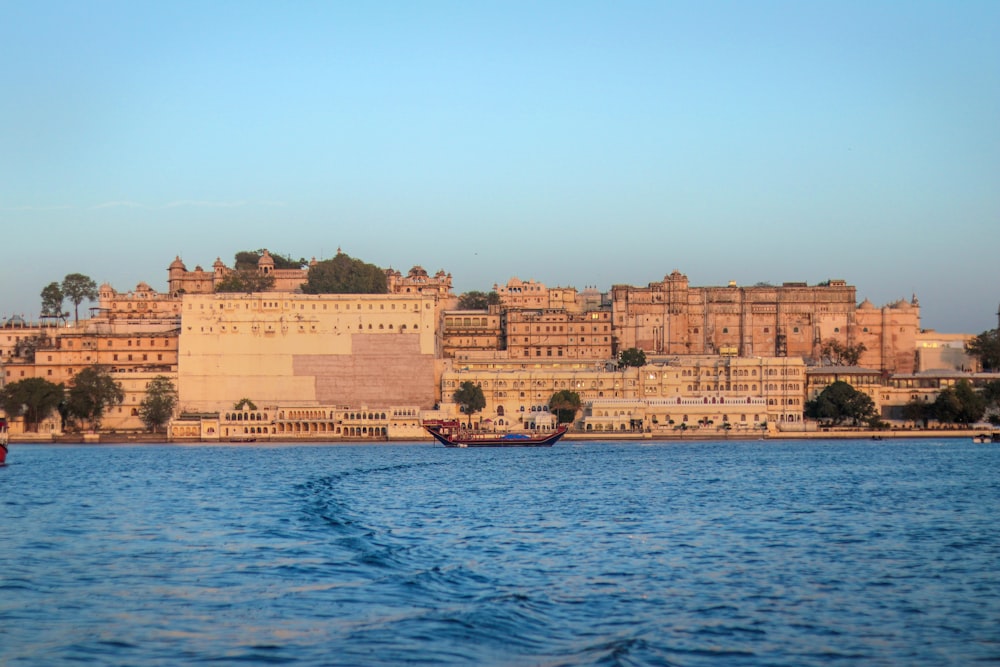 a body of water with boats in front of a large building