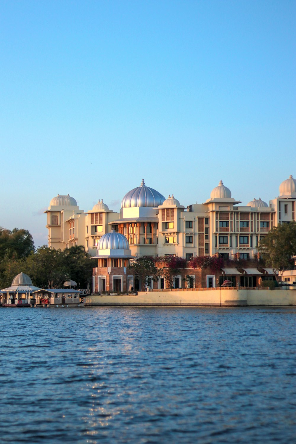 a large building sitting on the side of a lake