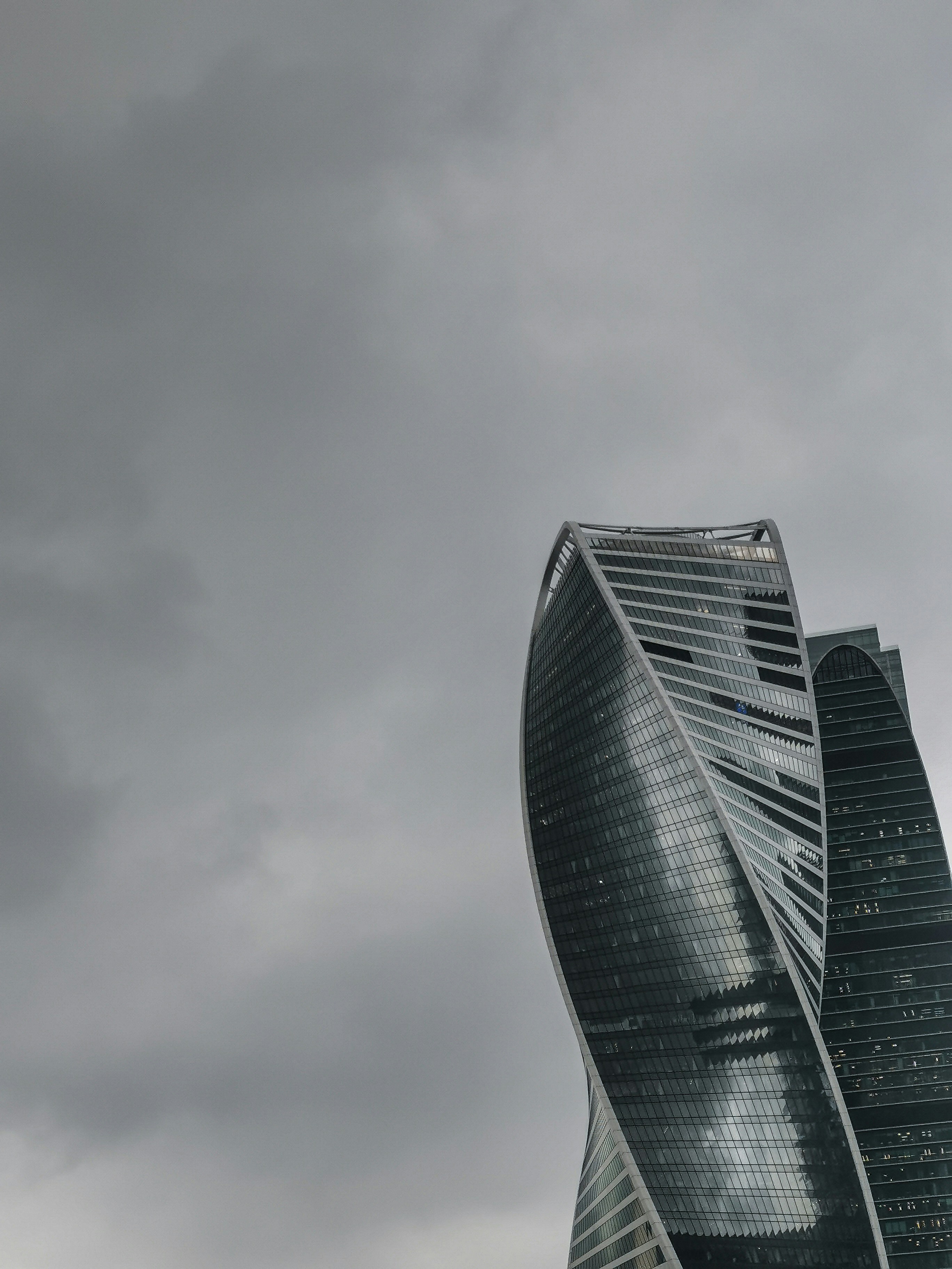 a very tall building sitting under a cloudy sky