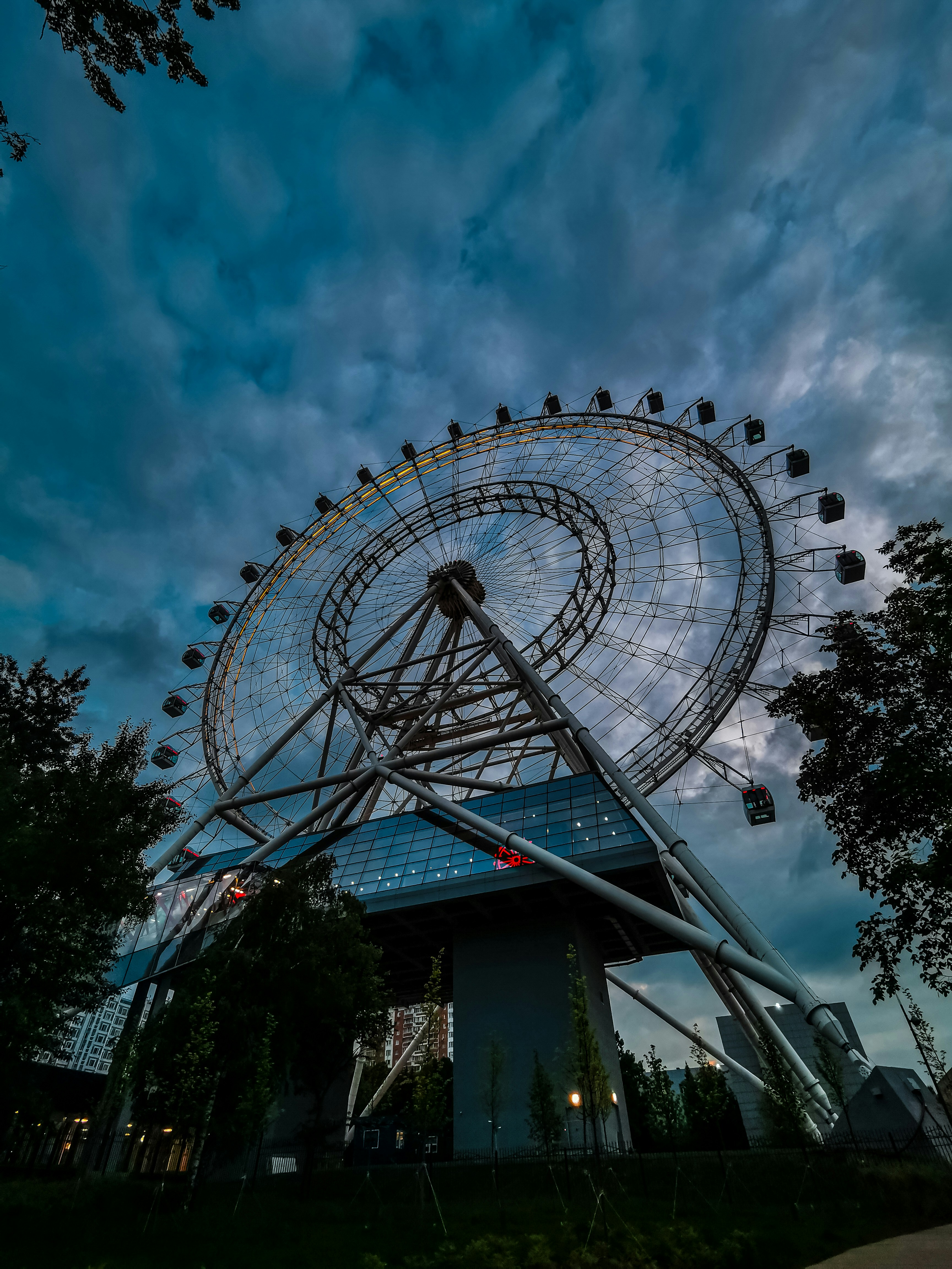 a large ferris wheel sitting on top of a lush green field