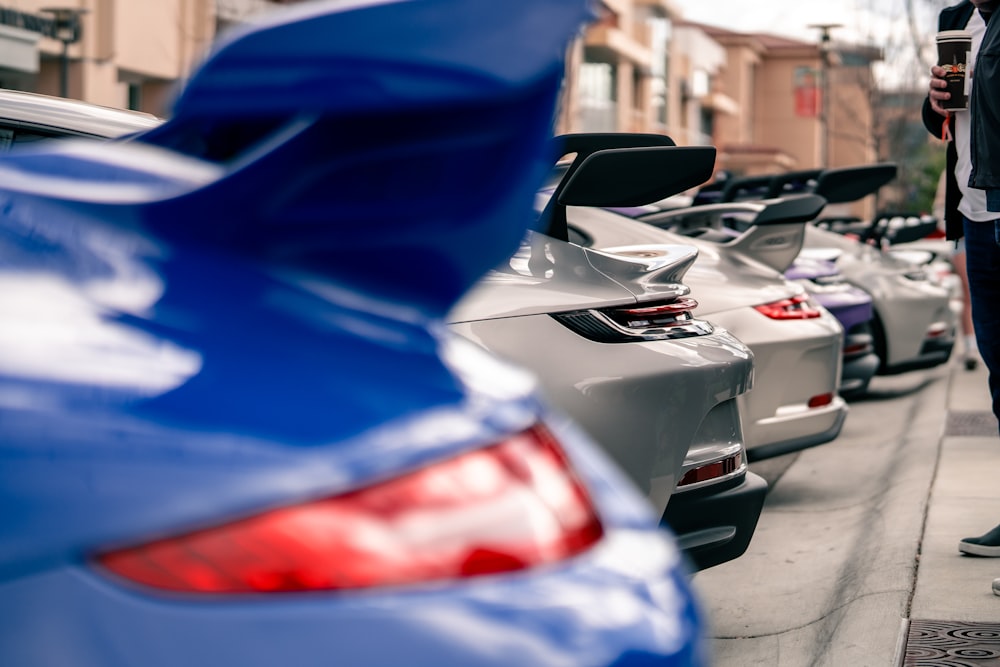 a man standing next to a row of parked cars