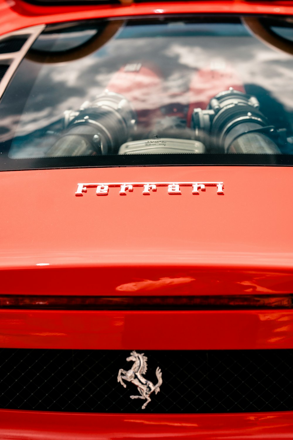 the hood of a red sports car with a ferrari logo on it