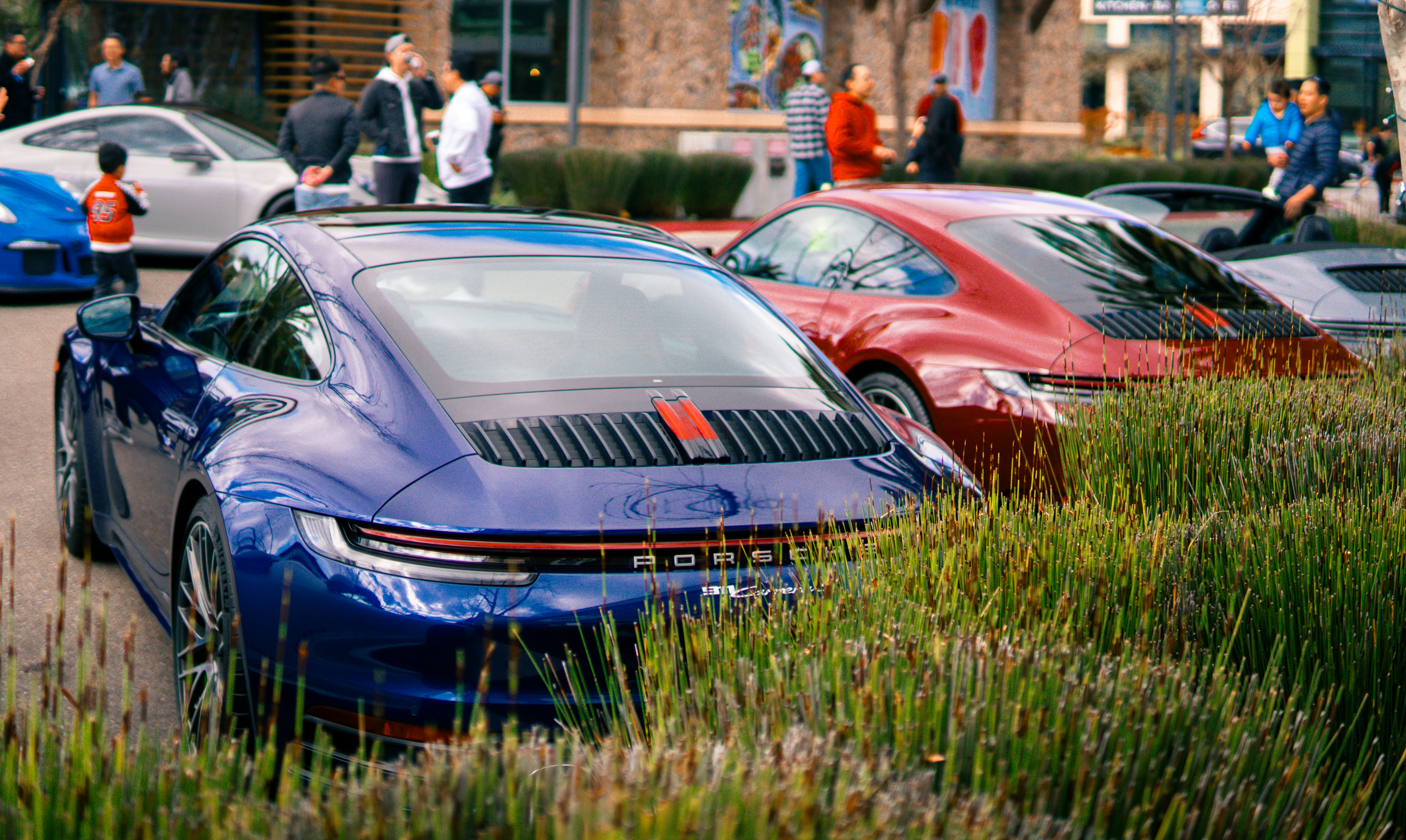 A group of cars parked next to each other in a parking lot photo – Free ...