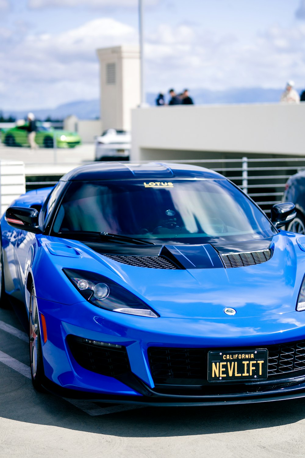 a blue sports car parked in a parking lot