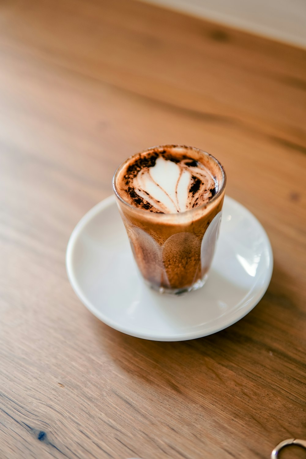 a cappuccino on a plate with a pair of scissors