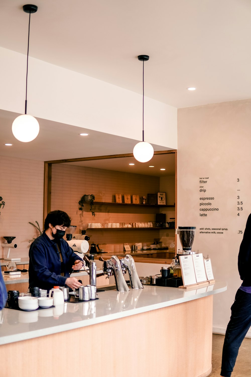 a man standing at a counter in a coffee shop