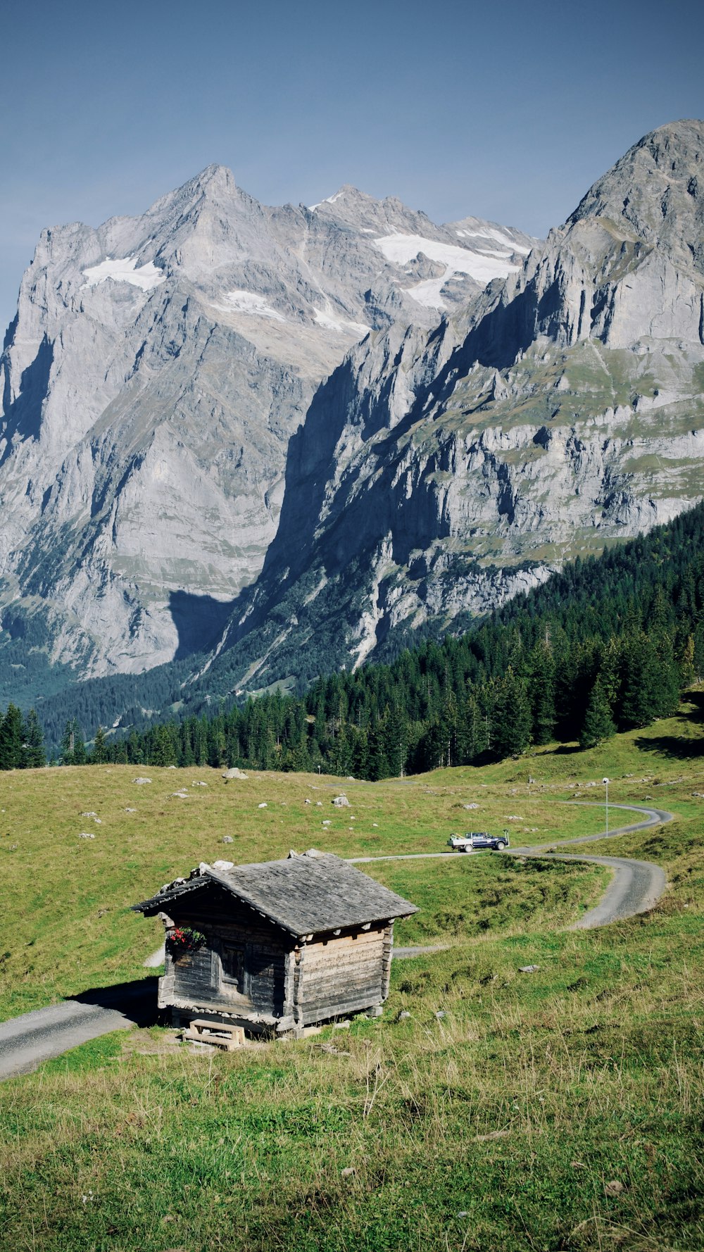 a small cabin in the middle of a grassy field