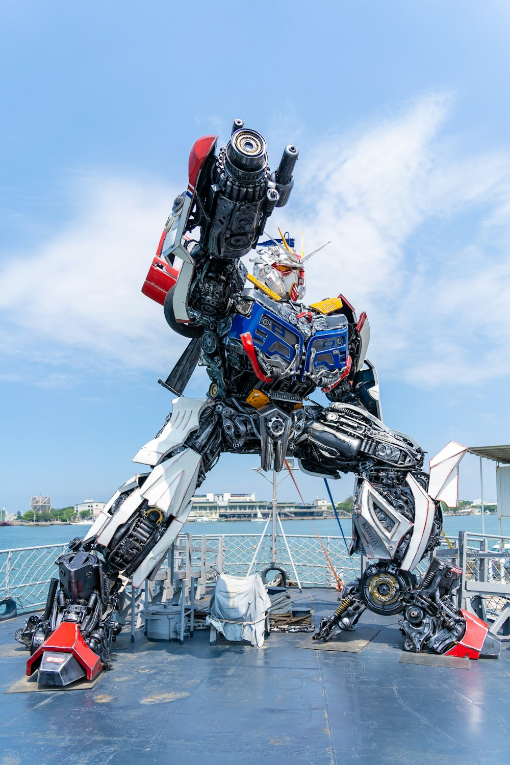 a large robot standing on top of a boat