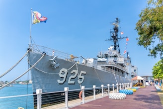 a large ship is docked at a pier