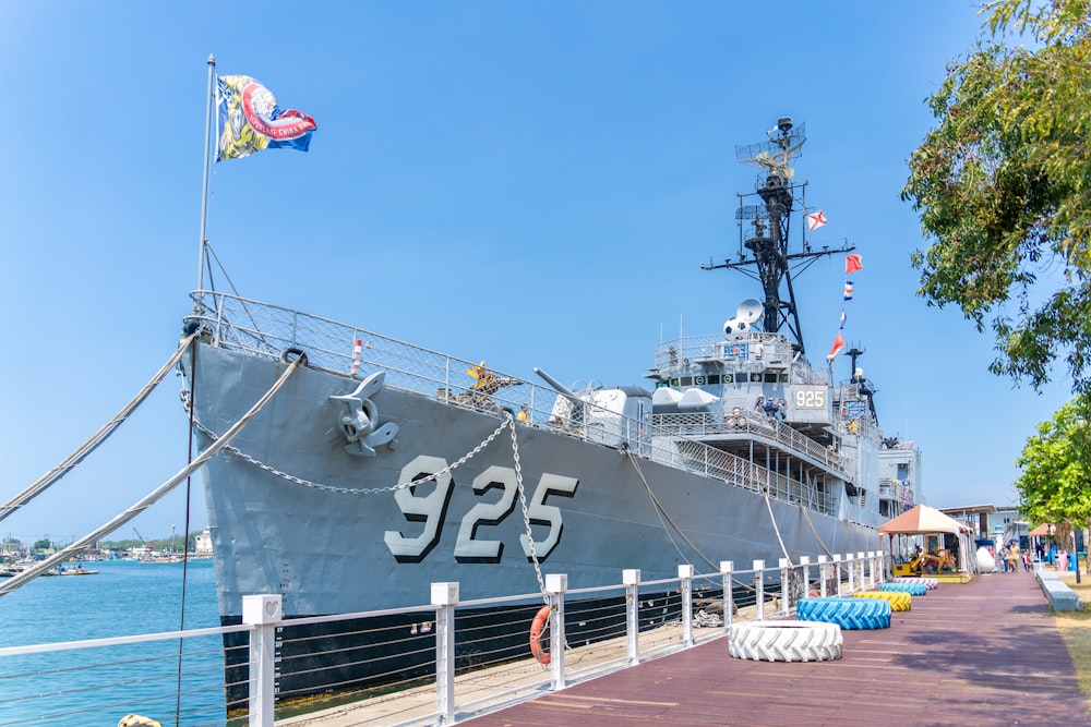 a large ship is docked at a pier