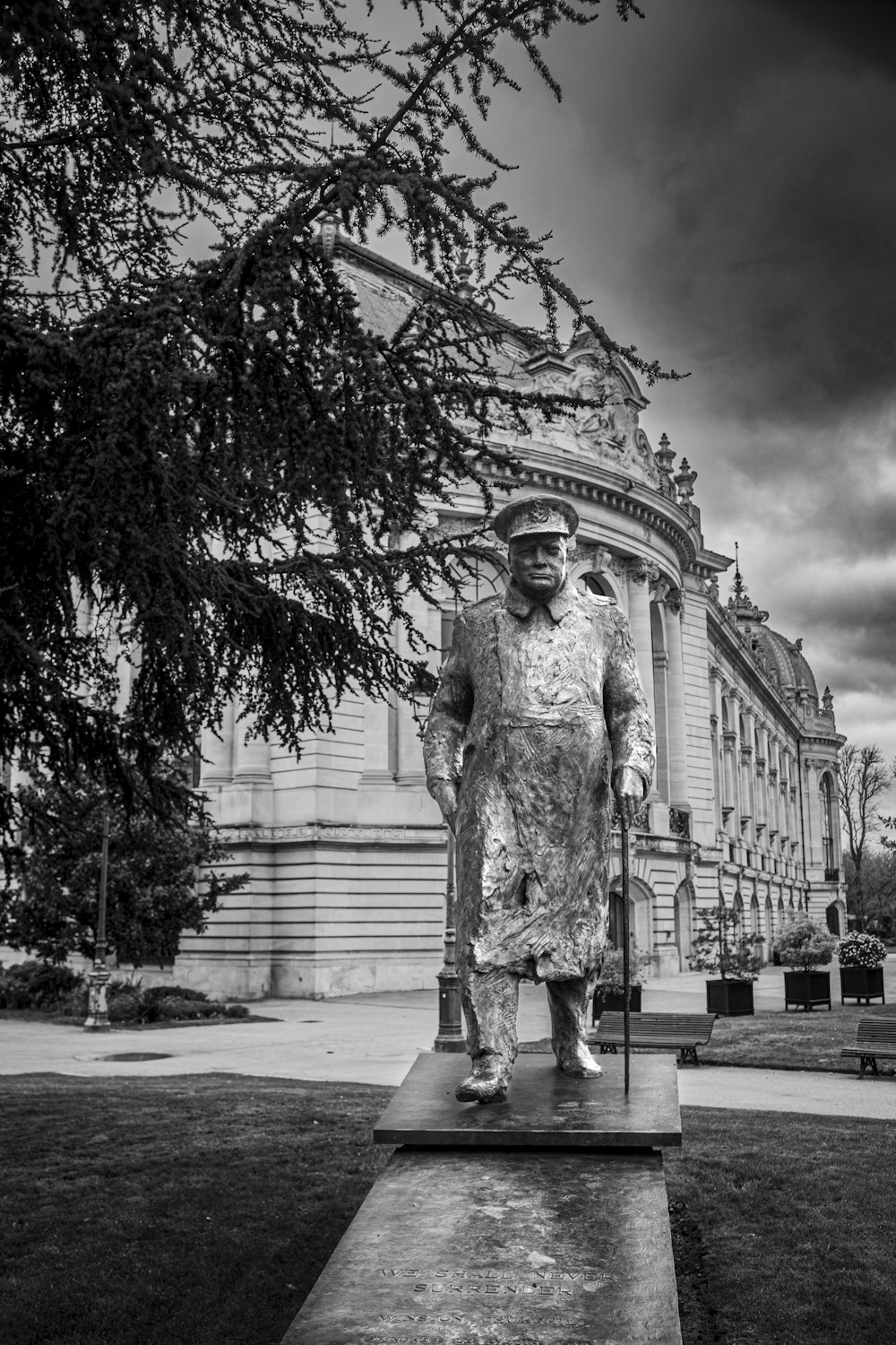 a statue of a man standing in front of a building