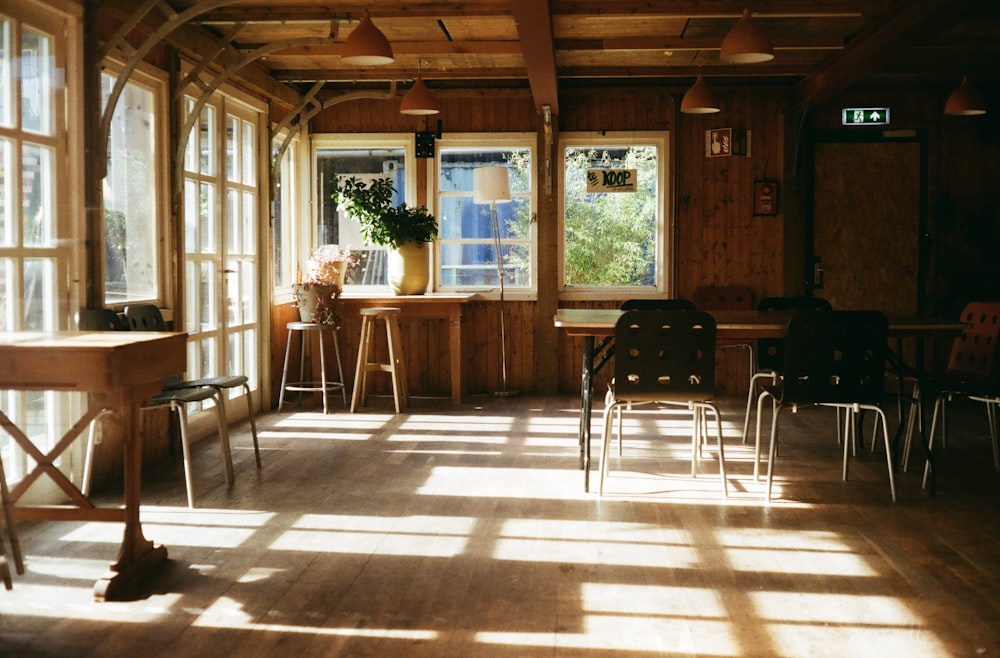 a room filled with lots of windows and lots of chairs