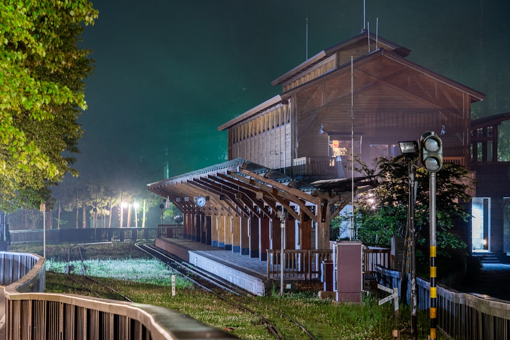 a train station at night with a train on the tracks