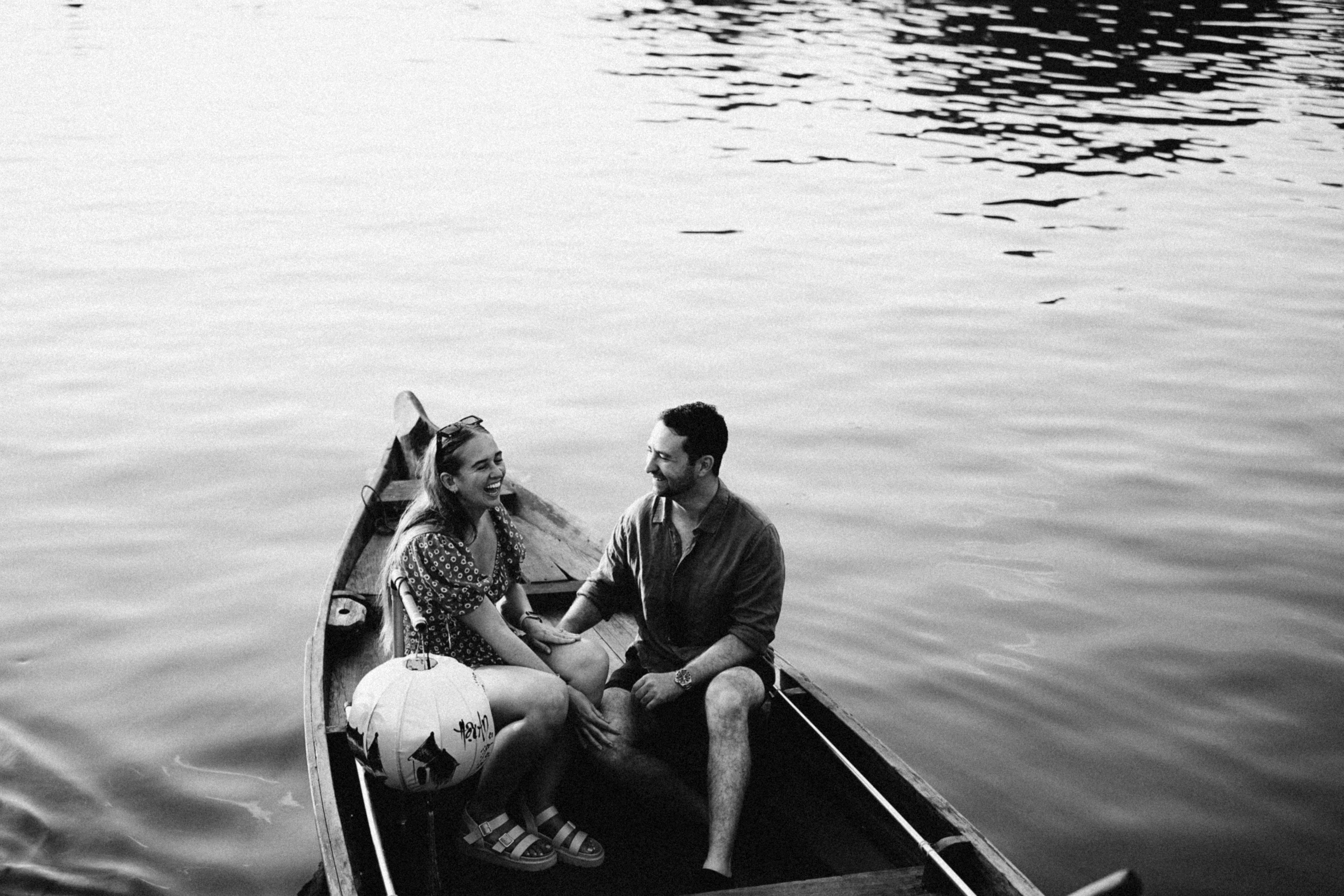 a man and a woman are sitting in a boat