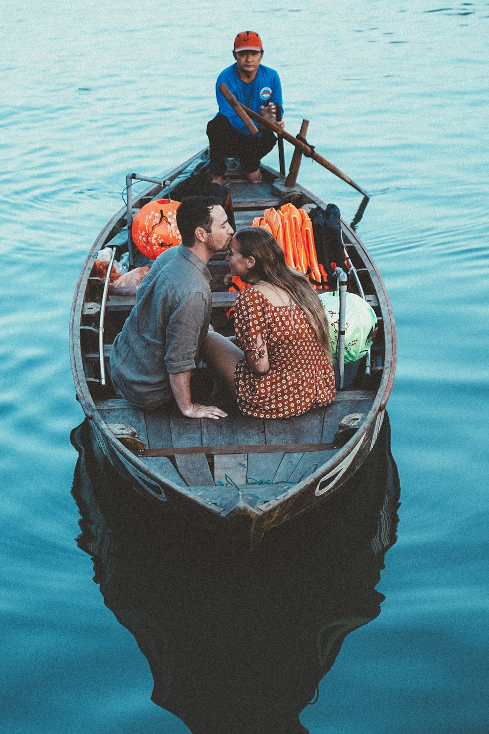 a man and a woman kissing in a boat