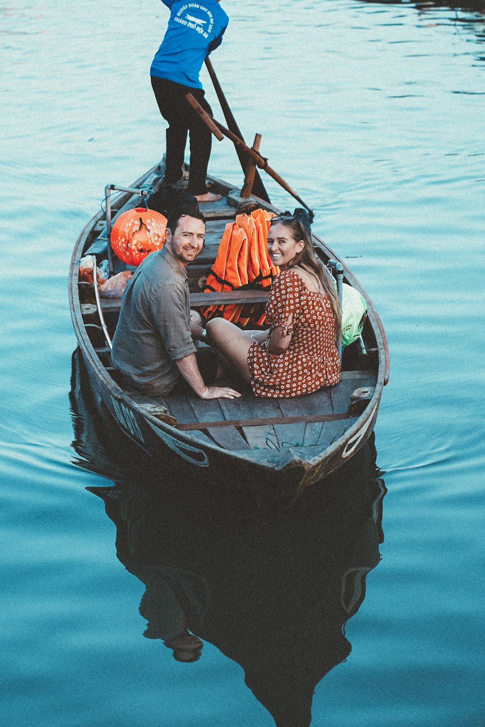 a group of people in a boat on a body of water