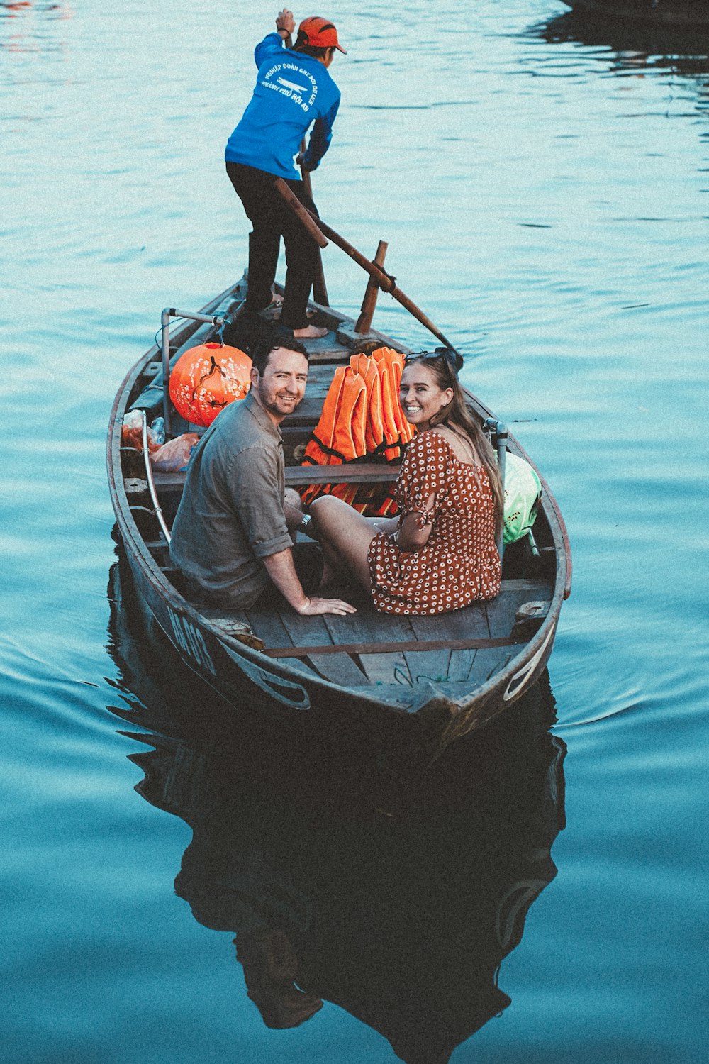 a man and a woman are sitting in a small boat