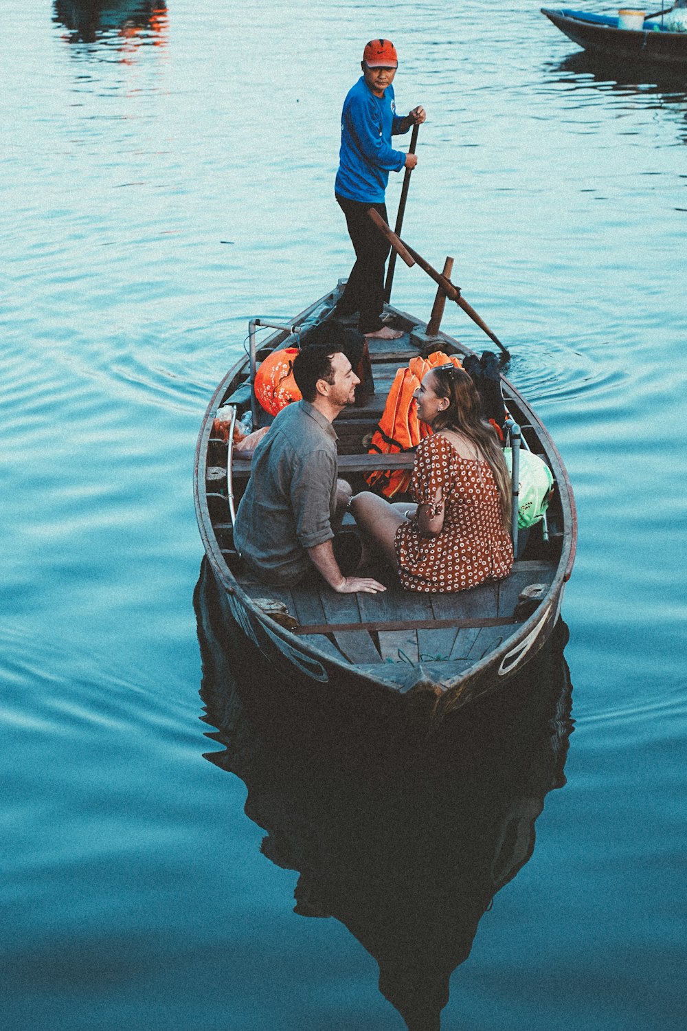 a man and a woman sitting in a small boat