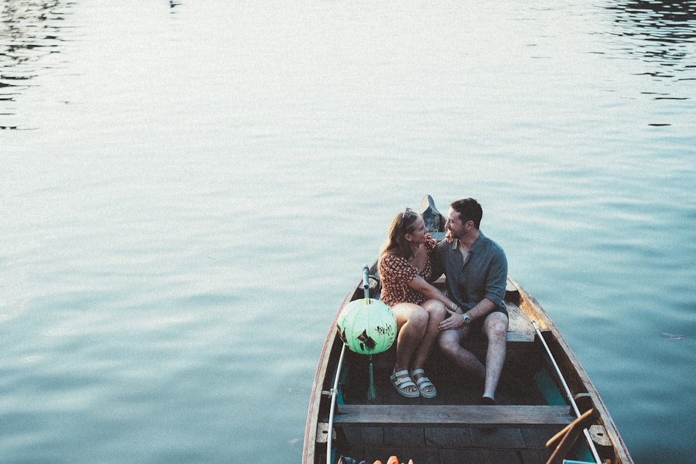 a man and a woman are sitting in a boat