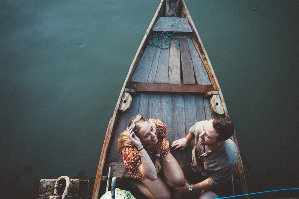 a man and a woman sitting in a boat