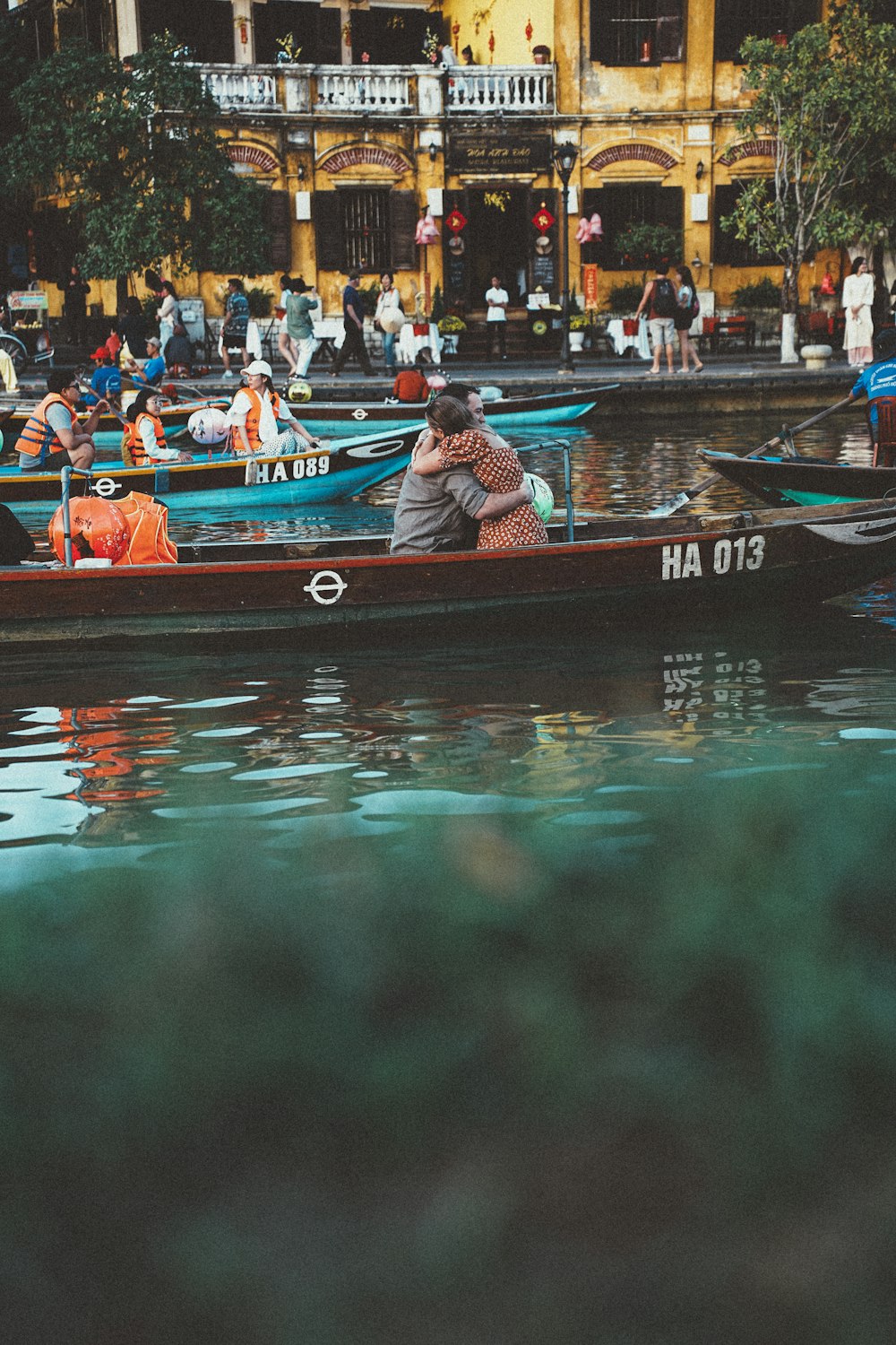 a couple of people in a small boat on a body of water