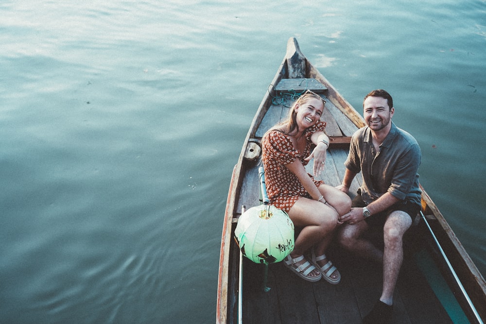 a man and a woman are sitting in a boat