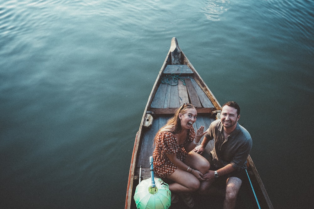 a man and a woman are sitting in a boat