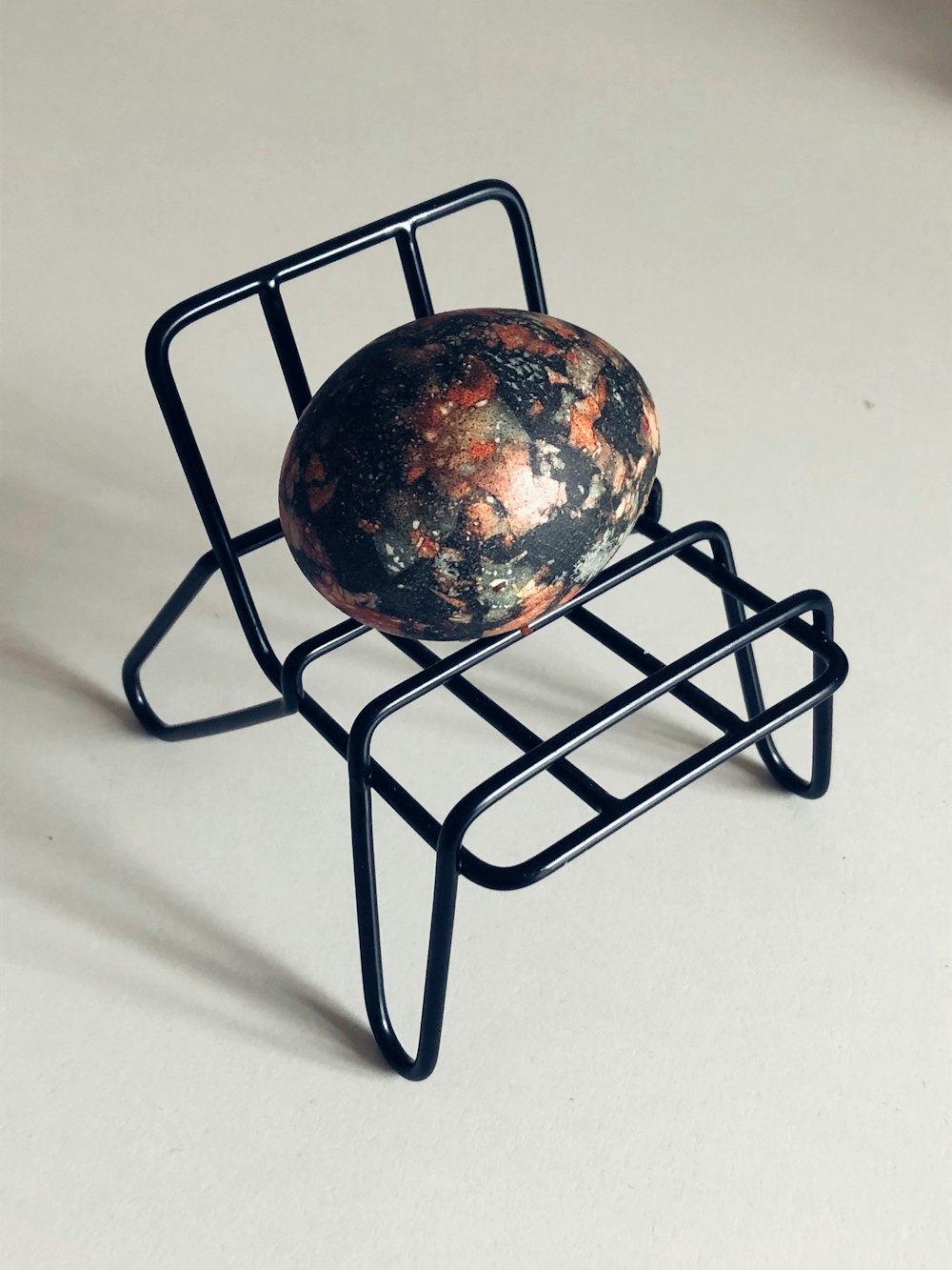 a rock sitting on top of a metal stand