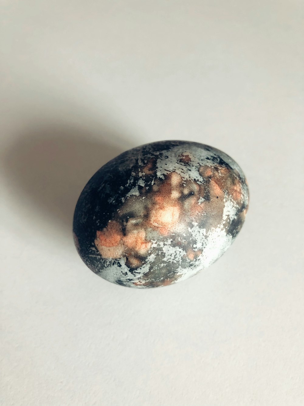 a black and white rock sitting on top of a white table