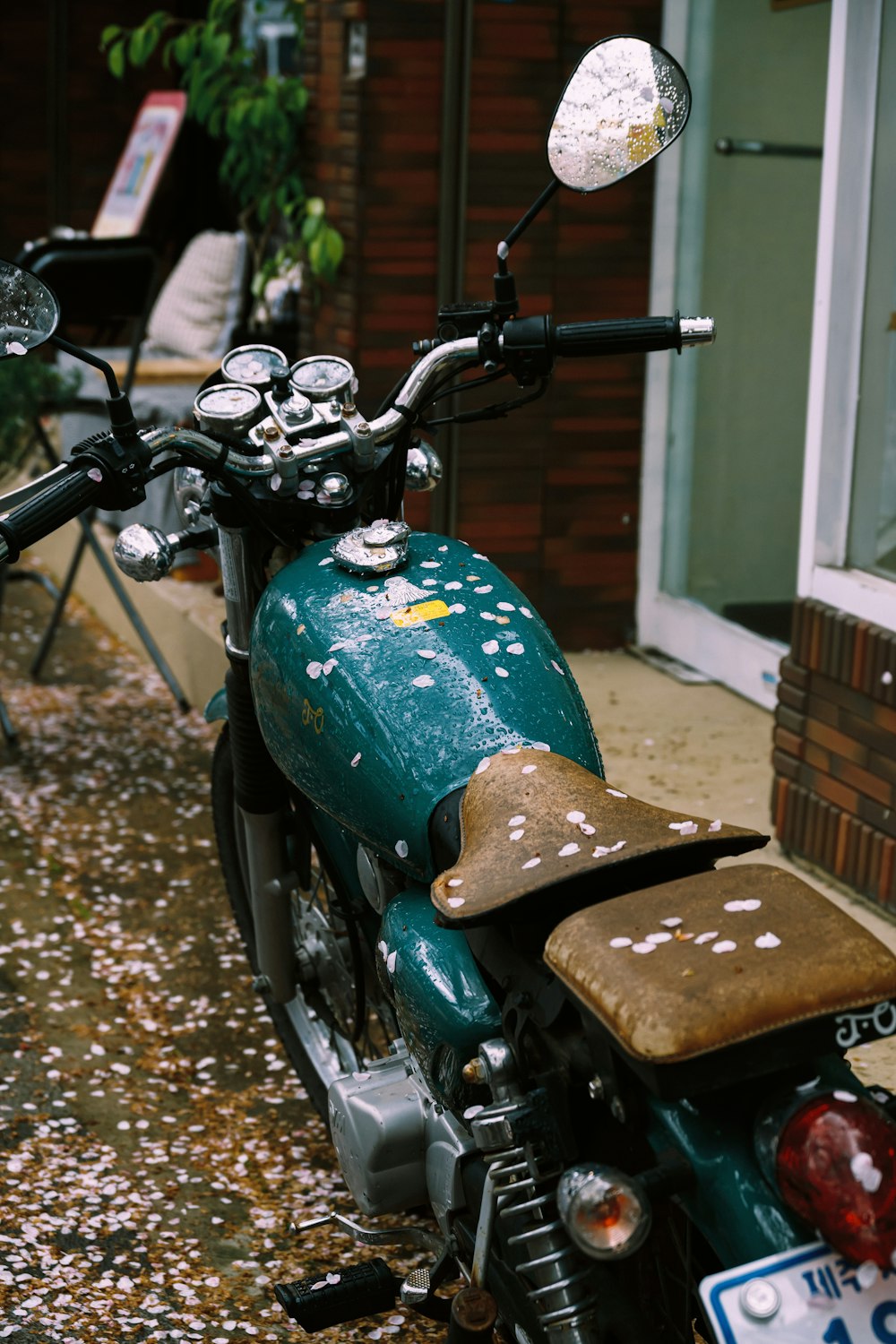 a green motorcycle parked in front of a building