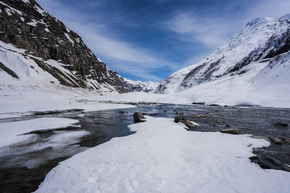 a river running through a snow covered valley