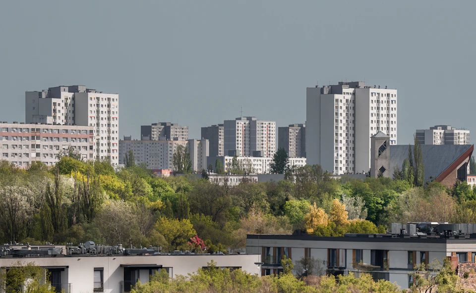 Panoramic view of diverse cityscape with tall buildings and varied architectural styles